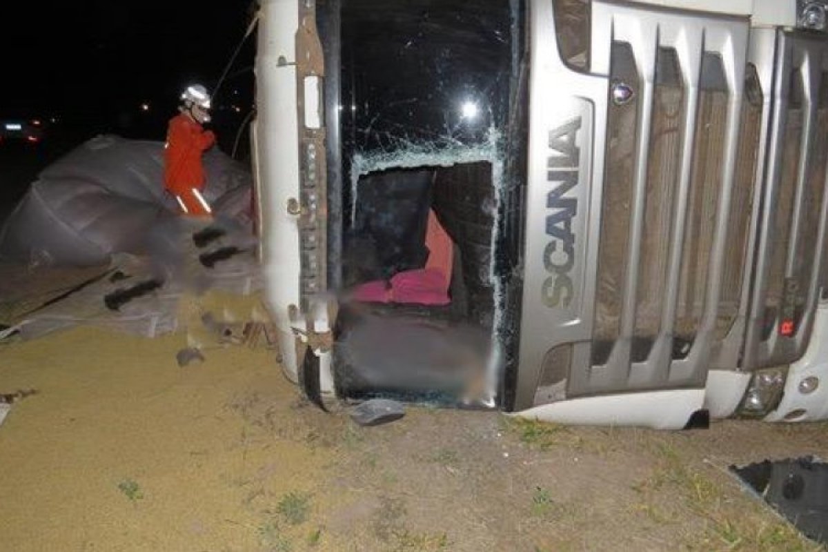 Mulher morre e motorista fica ferido após carreta com soja tombar na BA-460