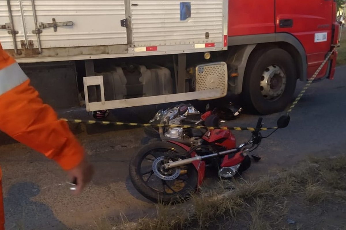 Após perder direção de moto, homem morre ao parar debaixo de caminhão 