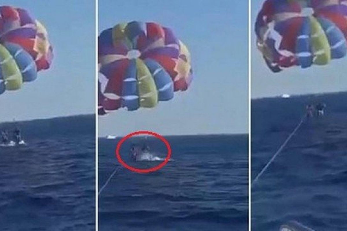 Vídeo: Tubarão salta d'água e morde pé de turista que praticava parasailing